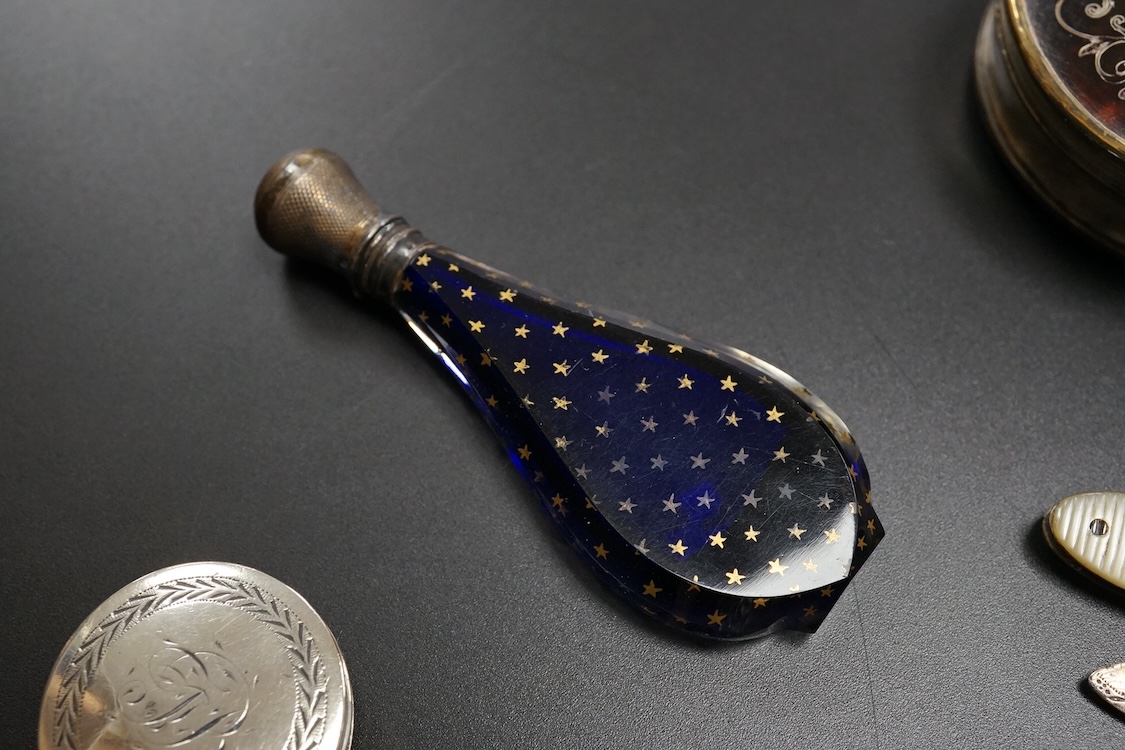 A collection of 19th century and later silver and white metal mounted items comprising three boxes, two glass scent bottles and a folding mother of pearl pen knife, largest 7.5cm high
